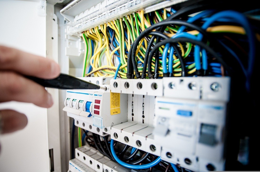 SJS Electrician in Huddersfield testing an electrical fuse box
